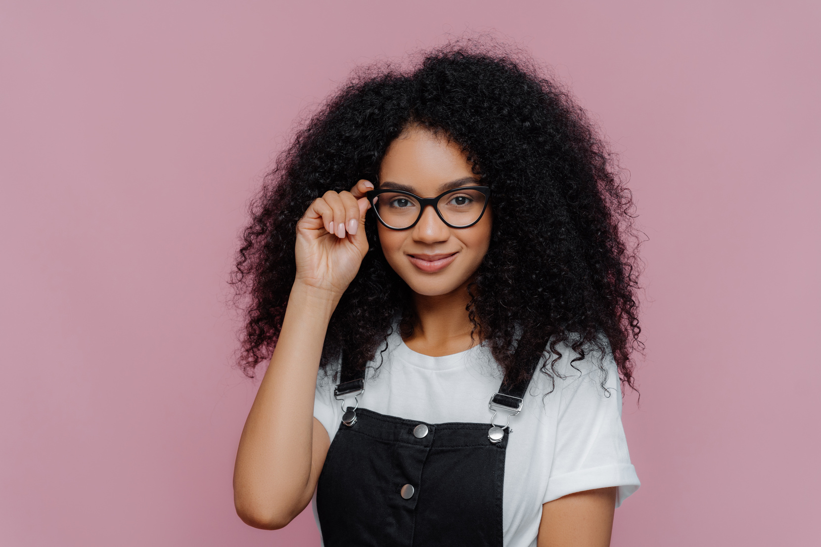 Woman Wearing Eyeglasses Posing on Pink Background